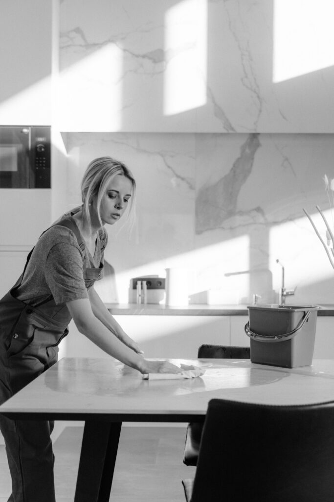 someone polishing a modern kitchen or cleaning professionally.